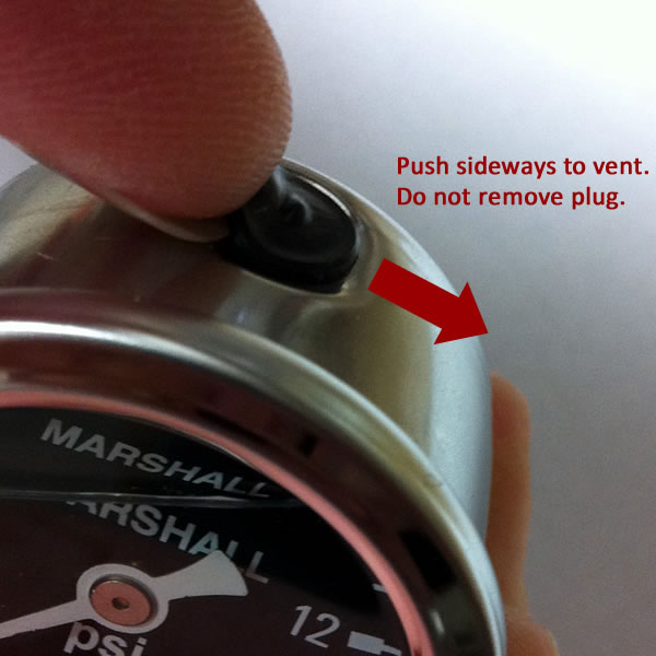 Venting a liquid filled gauge to equalize case pressure.
